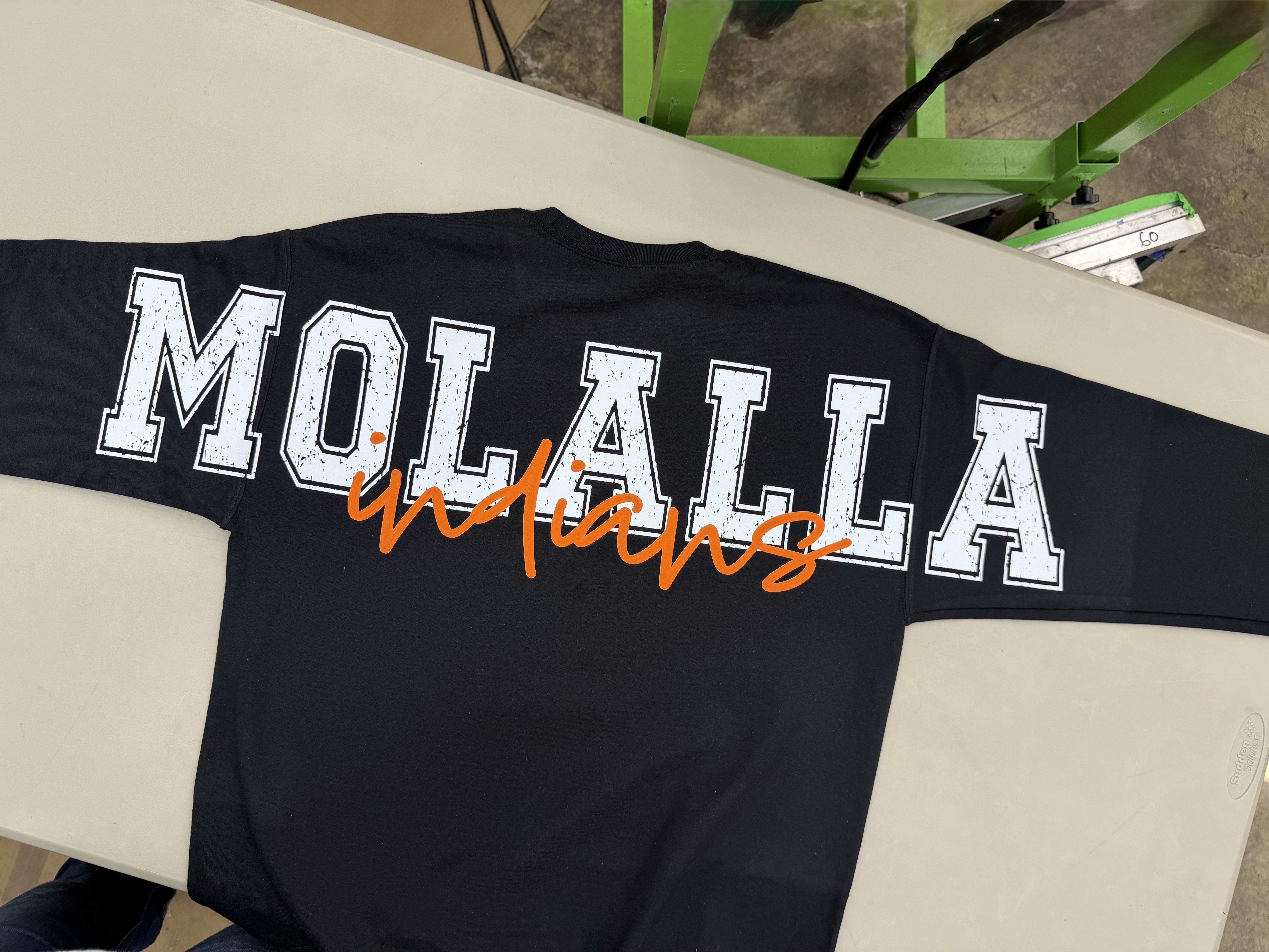 Finished black MOLALLA sweatshirt with white distressed block letters and orange indians script