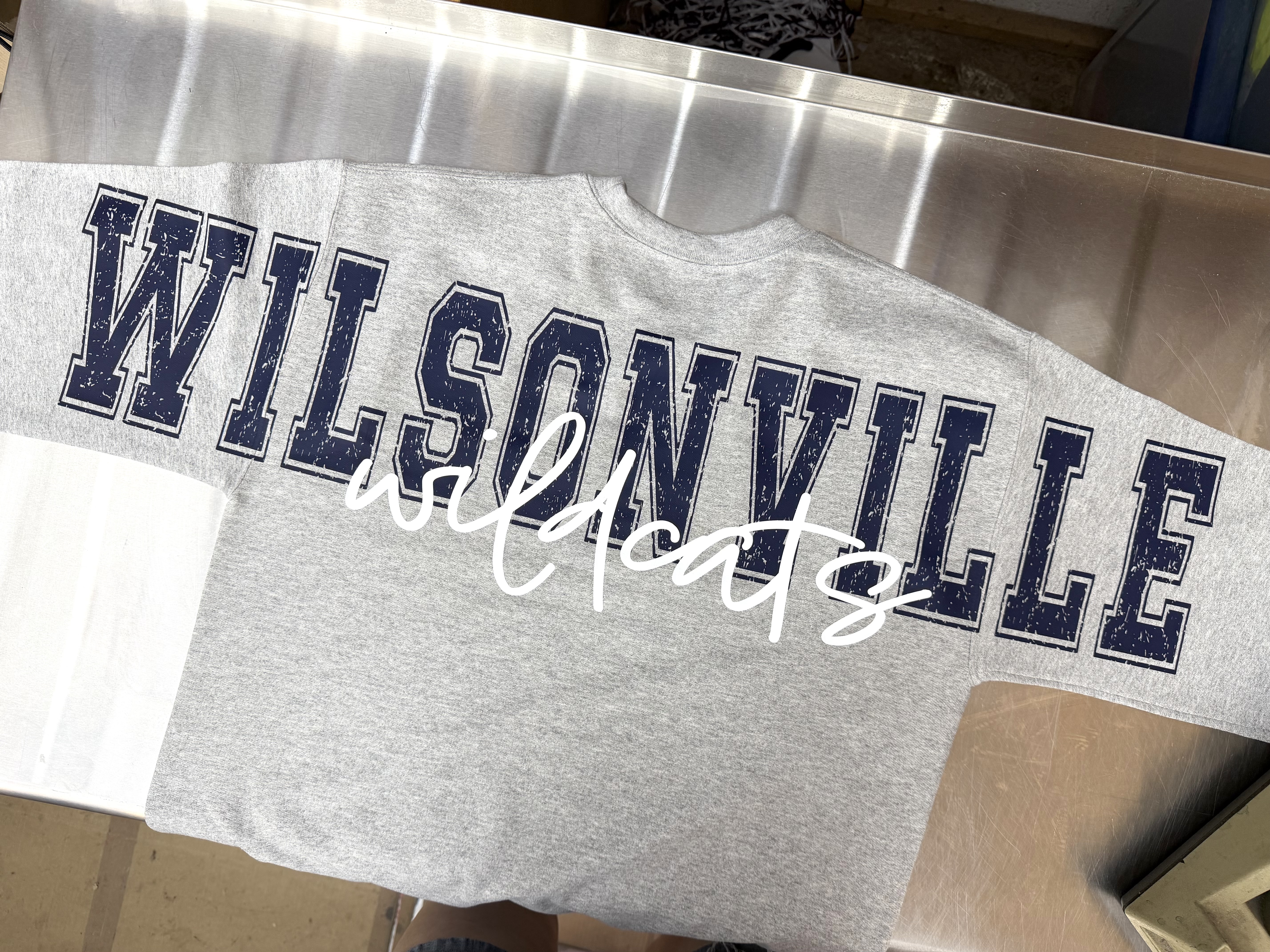 Finished gray WILSONVILLE sweatshirt with navy distressed block letters and white wildcats script