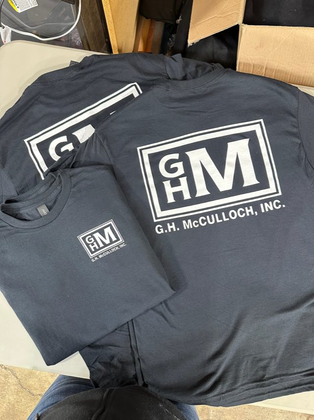 Charcoal t-shirts with the white G.H. McCulloch, Inc. logo on the left chest and full back