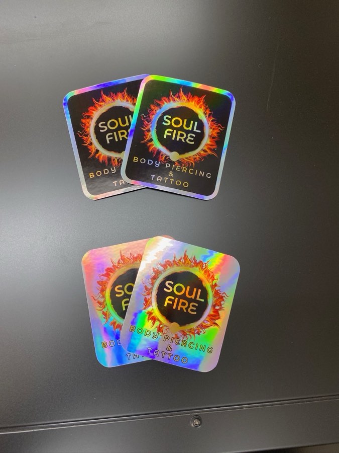 Holographic Soul Fire stickers on a dark table