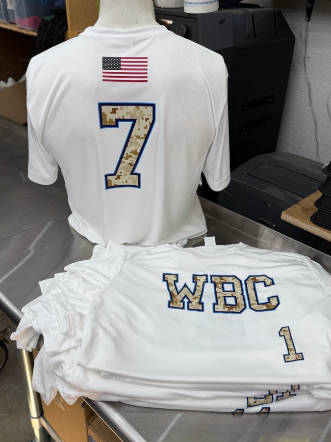 White jerseys with a flag, camo-filled WBC lettering and player numbers